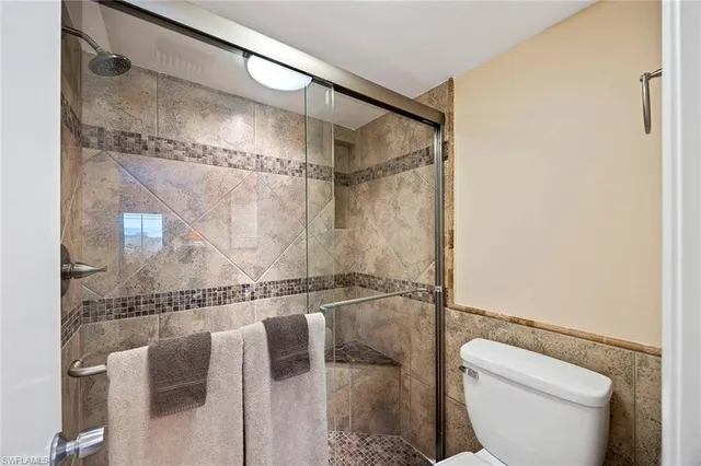 a bathroom with a glass shower door