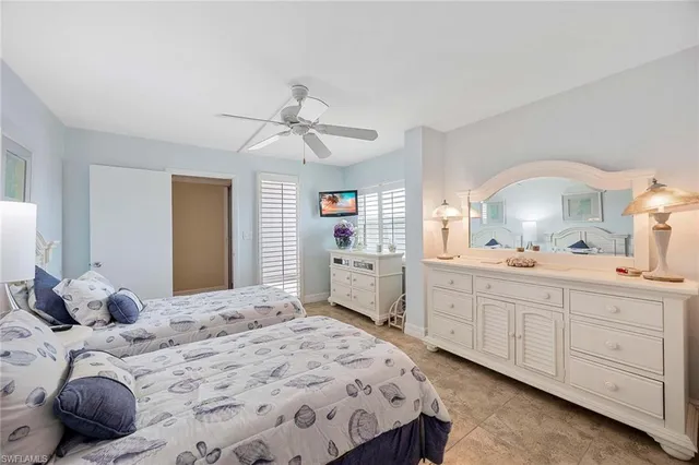 a bedroom with a bed a window and dresser