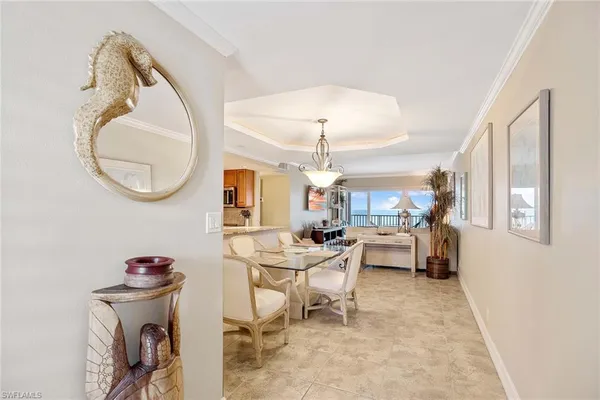 a living room with furniture a chandelier and a mirror
