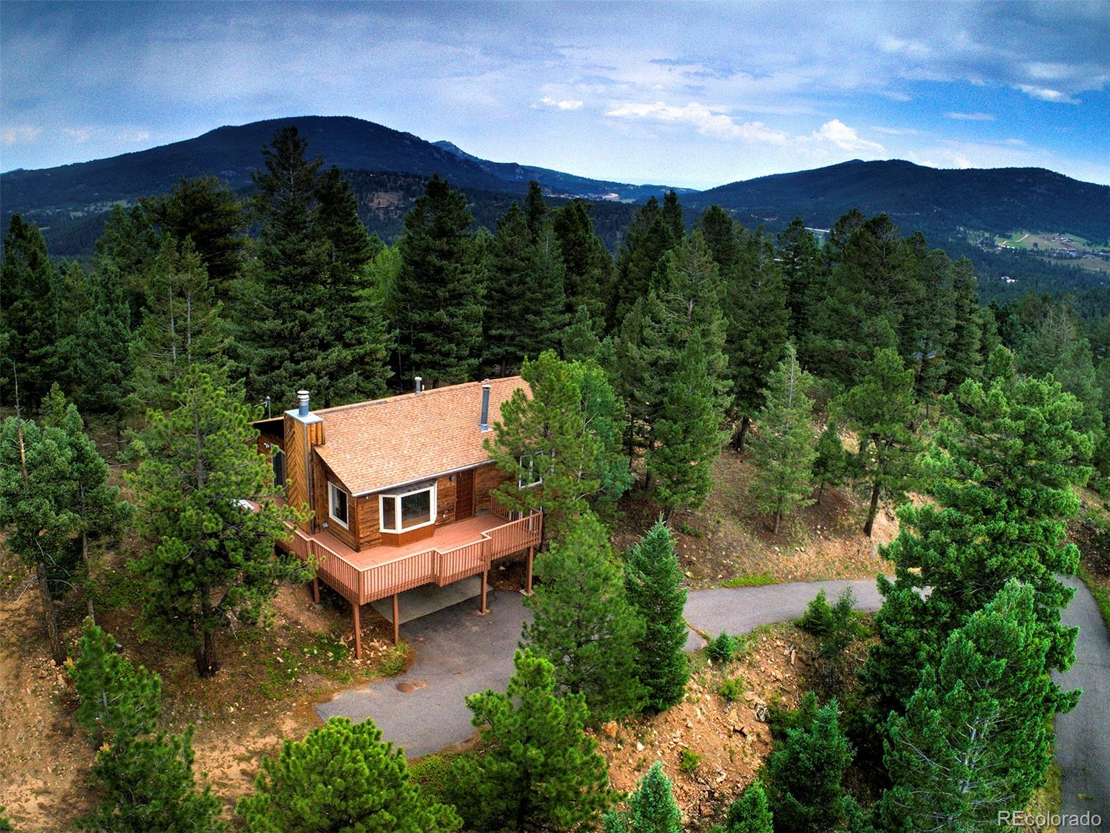 10042 Buena Vista Drive Conifer, CO 80433 - Photo 1 of 39 an aerial view of a house with mountain view