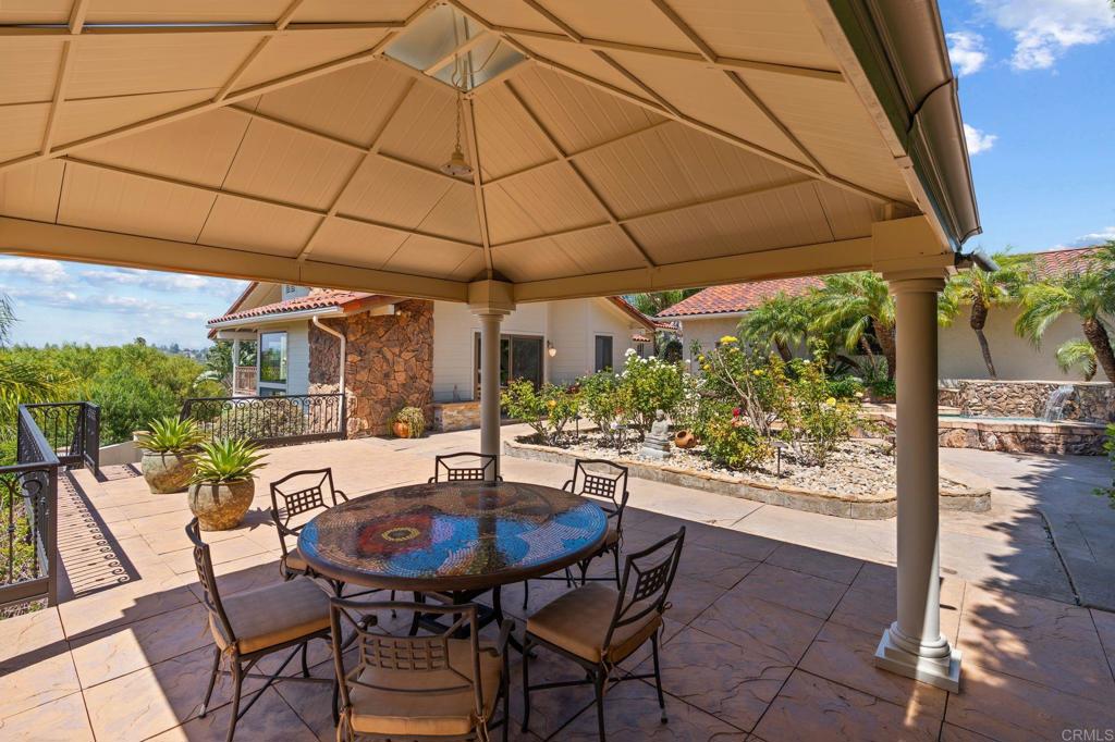 13319 Pacer Lane Poway, CA 92064 - Photo 51 of 75 a view of a patio with a table and chairs under an umbrella