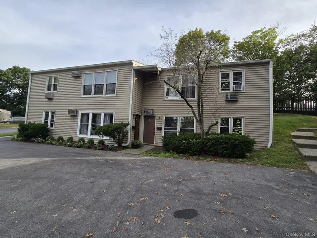 a front view of a house with a yard and a garage