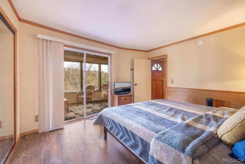 1179 Ridge Road Fawnskin, CA 92333 - Photo 28 of 43 a bedroom with a large bed and a large window