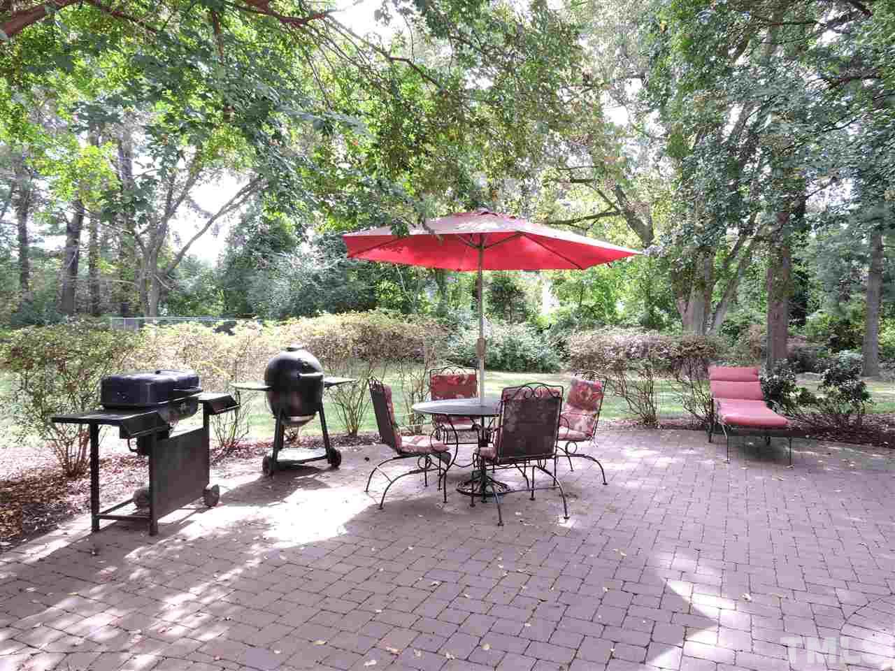 176 Alleghany Drive Roxboro, NC 27573 - Photo 22 of 25 a view of a patio with a table and chairs under an umbrella