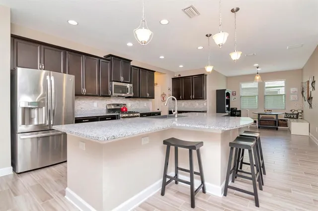a view of a patio with lawn chairs under an umbrella