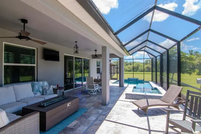 a living room with furniture and a view of kitchen