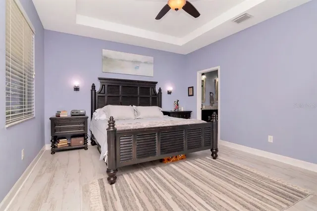 an aerial view of a house with swimming pool and outdoor seating