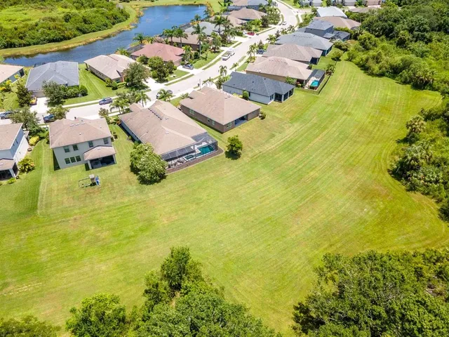 a kitchen with stainless steel appliances granite countertop wooden cabinets a sink dishwasher a stove and a refrigerator