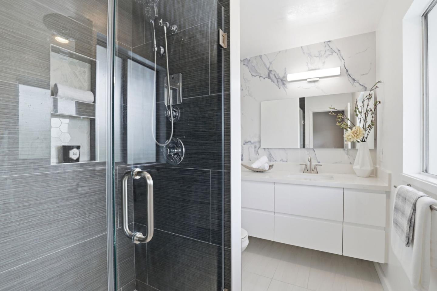 255 South Rengstorff Avenue, Unit 2 Mountain View, CA 94040 - Photo 17 of 25 a bathroom with a double vanity sink mirror and shower