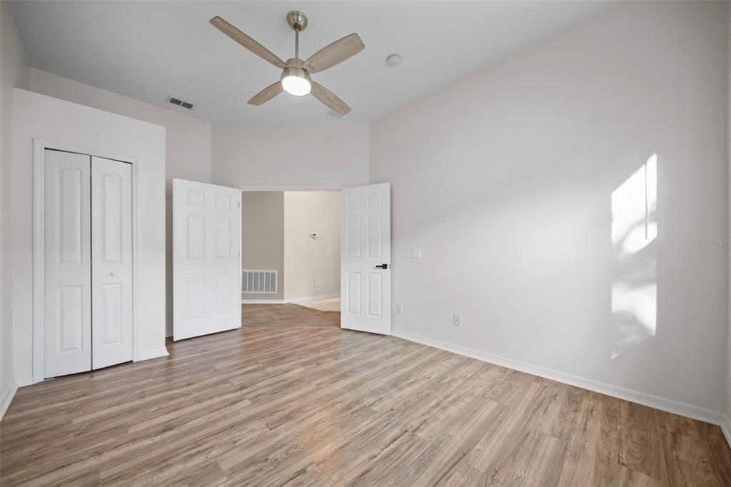 2217 Caledonian Street Clermont, FL 34711 - Photo 11 of 23 an empty room with wooden floor and windows
