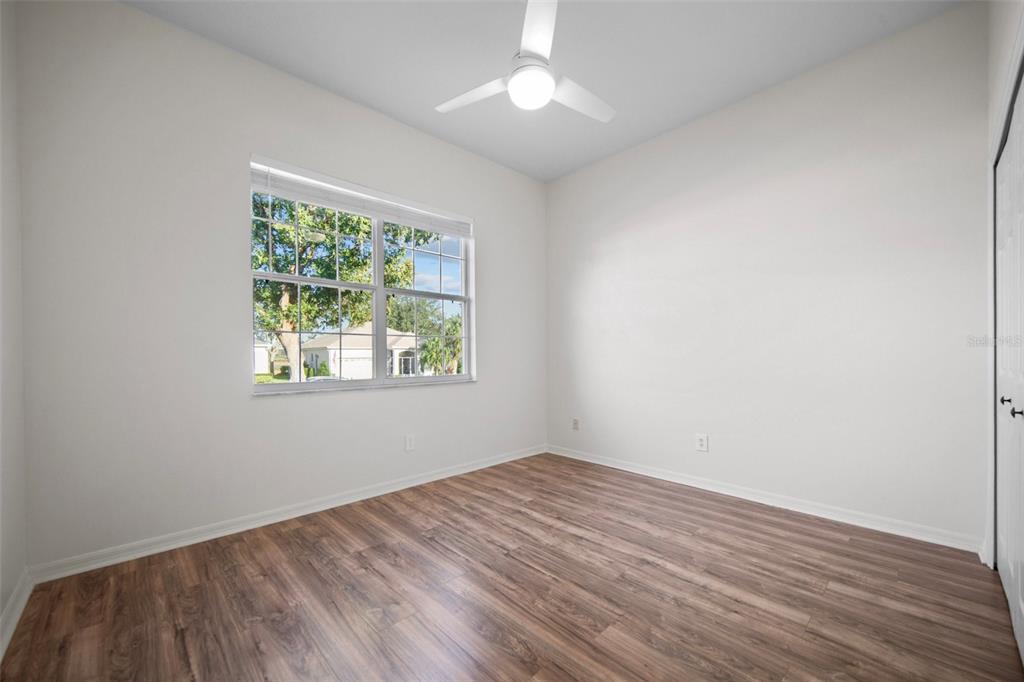 2217 Caledonian Street Clermont, FL 34711 - Photo 13 of 23 an empty room with wooden floor and windows