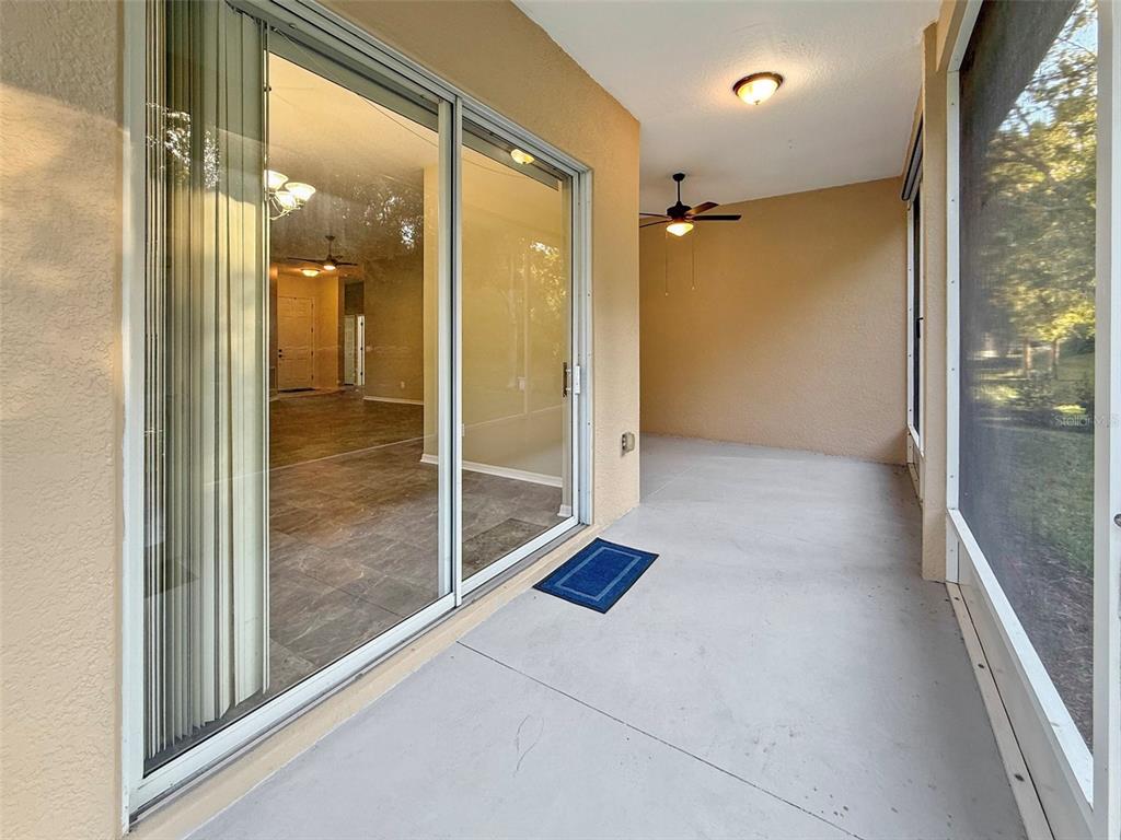 2217 Caledonian Street Clermont, FL 34711 - Photo 19 of 23 a view of a hallway with wooden floor and a glass door