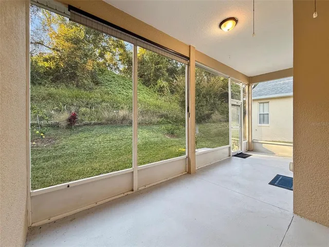 a view of an empty room and glass door