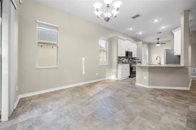 a view of a kitchen with a sink and cabinets