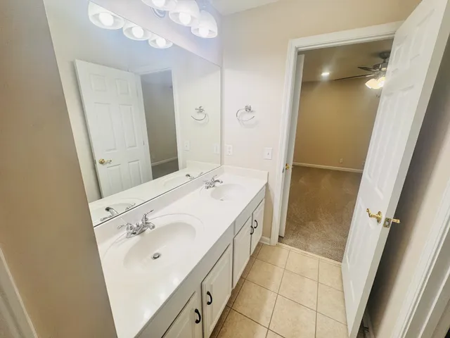 a bathroom with a sink a mirror and a shower