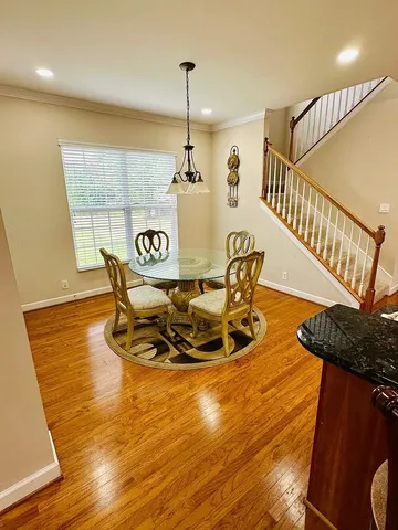 a view of a dining room with furniture wooden floor and chandelier
