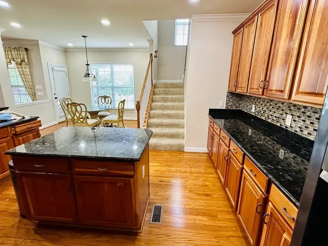 a kitchen with sink and refrigerator