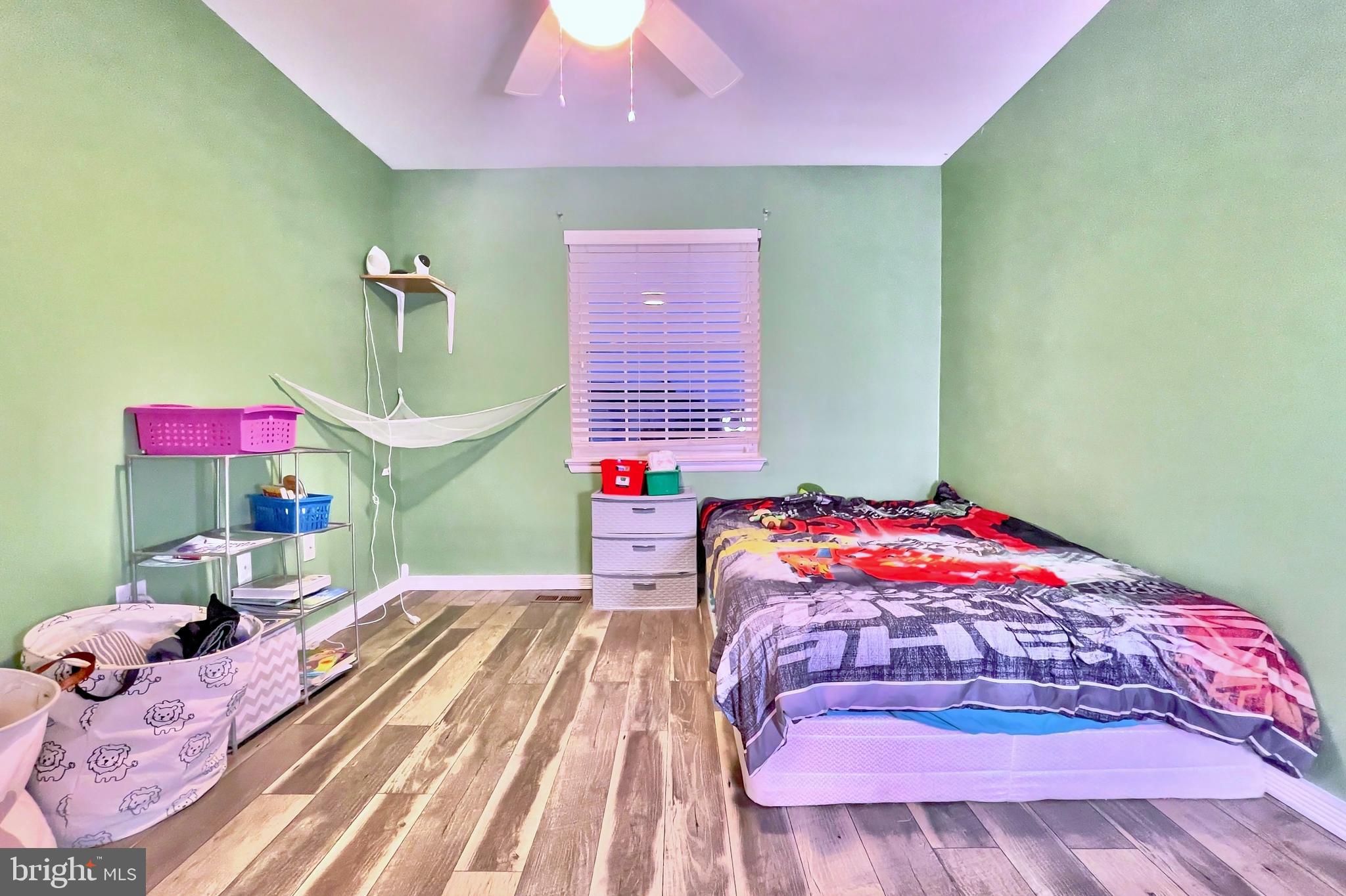 6852 Carnation Circle Frederick, MD 21703 - Photo 13 of 22 a bedroom with a bed and a chandelier