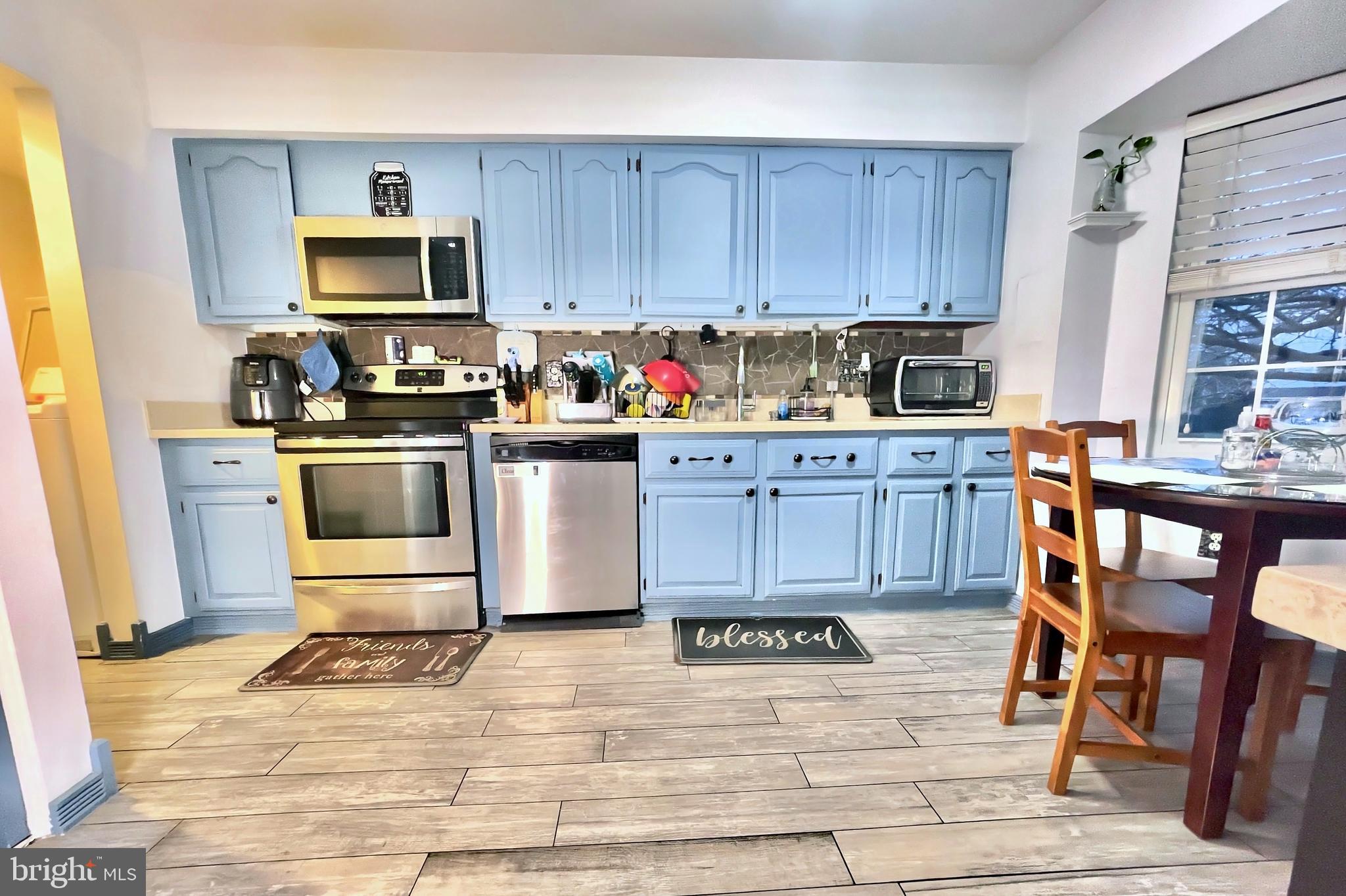 6852 Carnation Circle Frederick, MD 21703 - Photo 4 of 22 a kitchen with wooden cabinets and stainless steel appliances