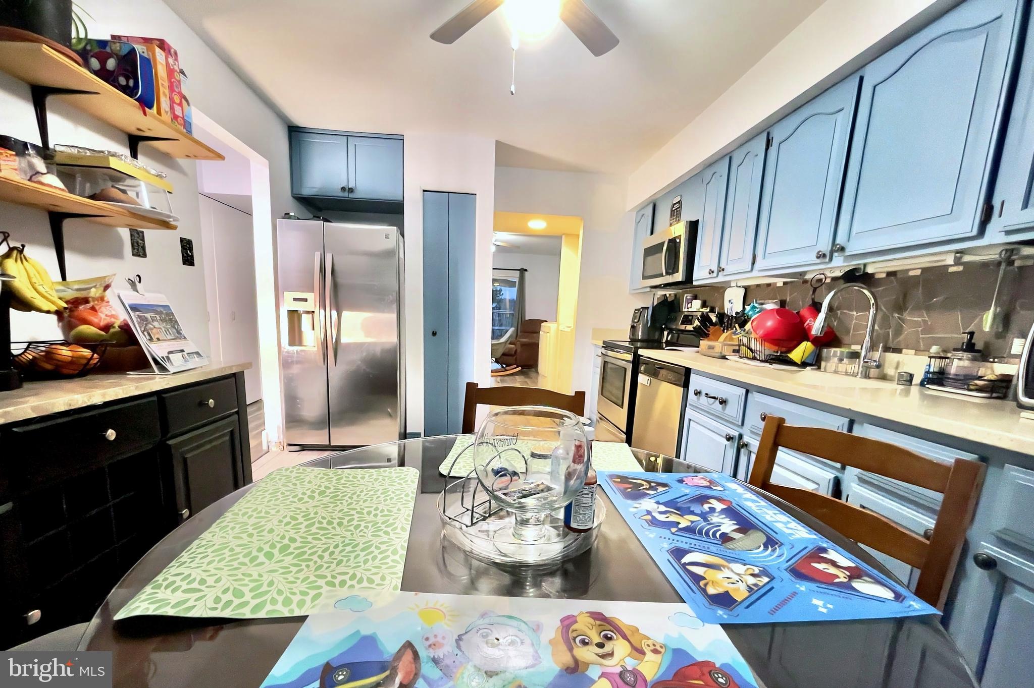 6852 Carnation Circle Frederick, MD 21703 - Photo 5 of 22 a very nice looking open kitchen with stainless steel appliances granite countertop a stove a sink dishwasher and cabinets with wooden floor
