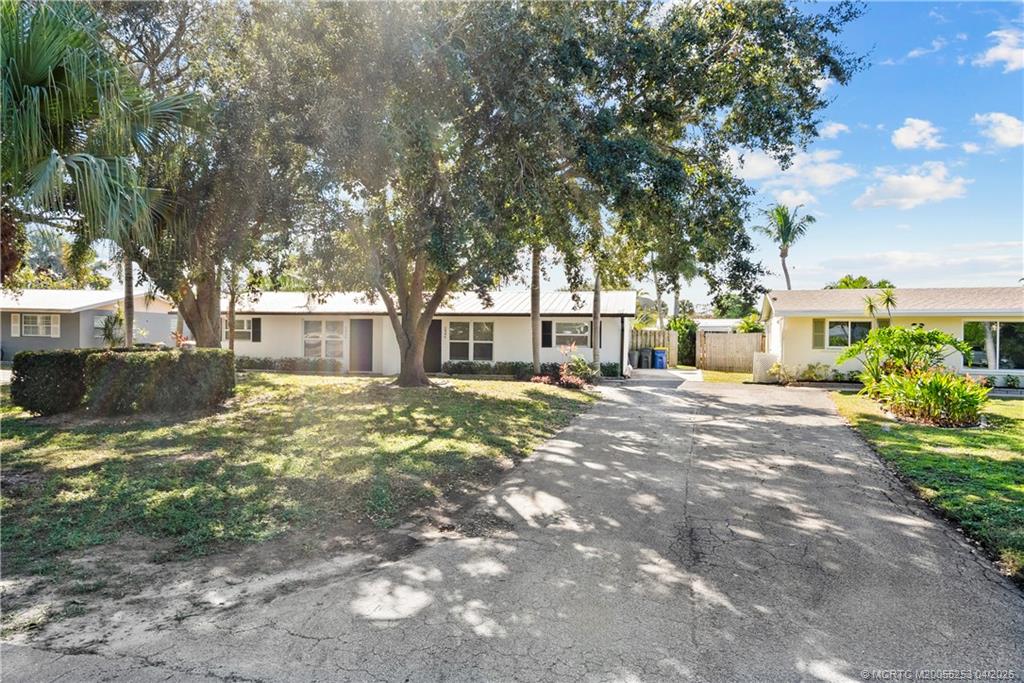 2446-2456 Southwest Hideaway Lane Stuart, FL 34994 - Photo 1 of 42 a view of a yard with a large tree