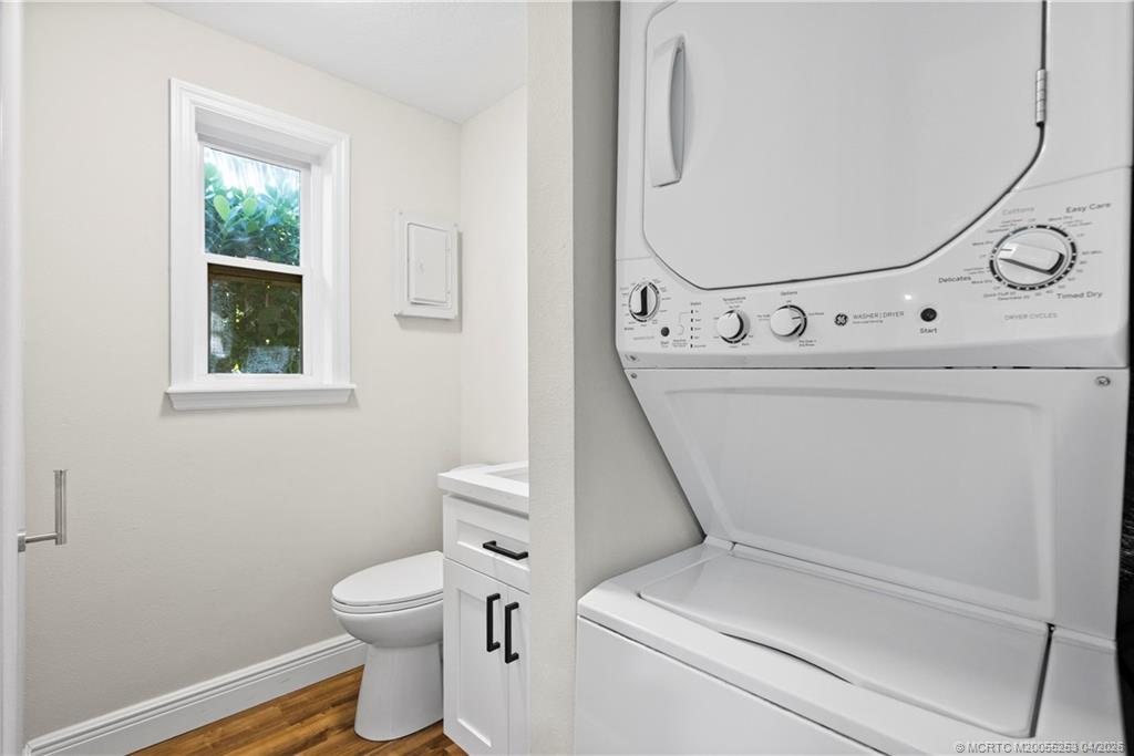 2446-2456 Southwest Hideaway Lane Stuart, FL 34994 - Photo 13 of 42 a bathroom with a toilet and a mirror