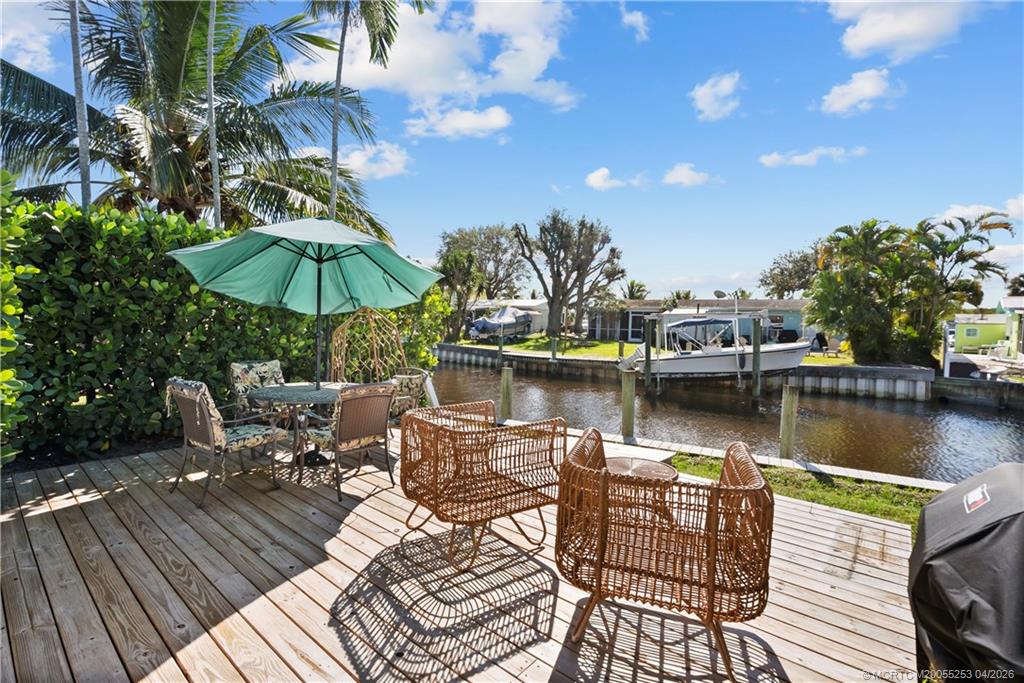 2446-2456 Southwest Hideaway Lane Stuart, FL 34994 - Photo 25 of 42 a view of a lake with sitting area