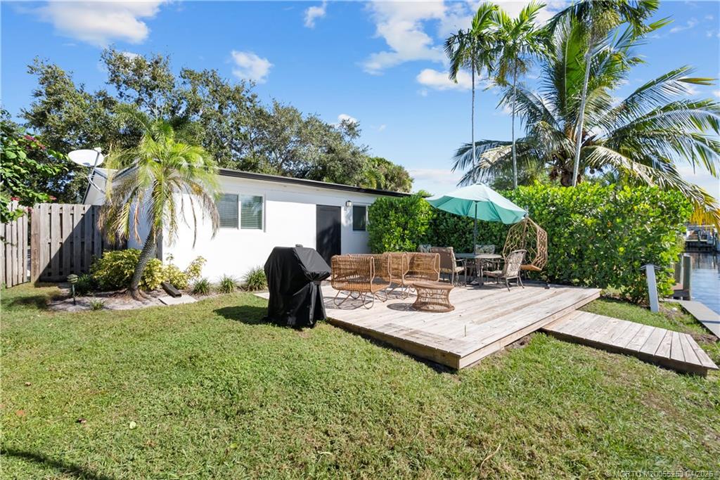2446-2456 Southwest Hideaway Lane Stuart, FL 34994 - Photo 26 of 42 a view of a house with backyard and sitting area