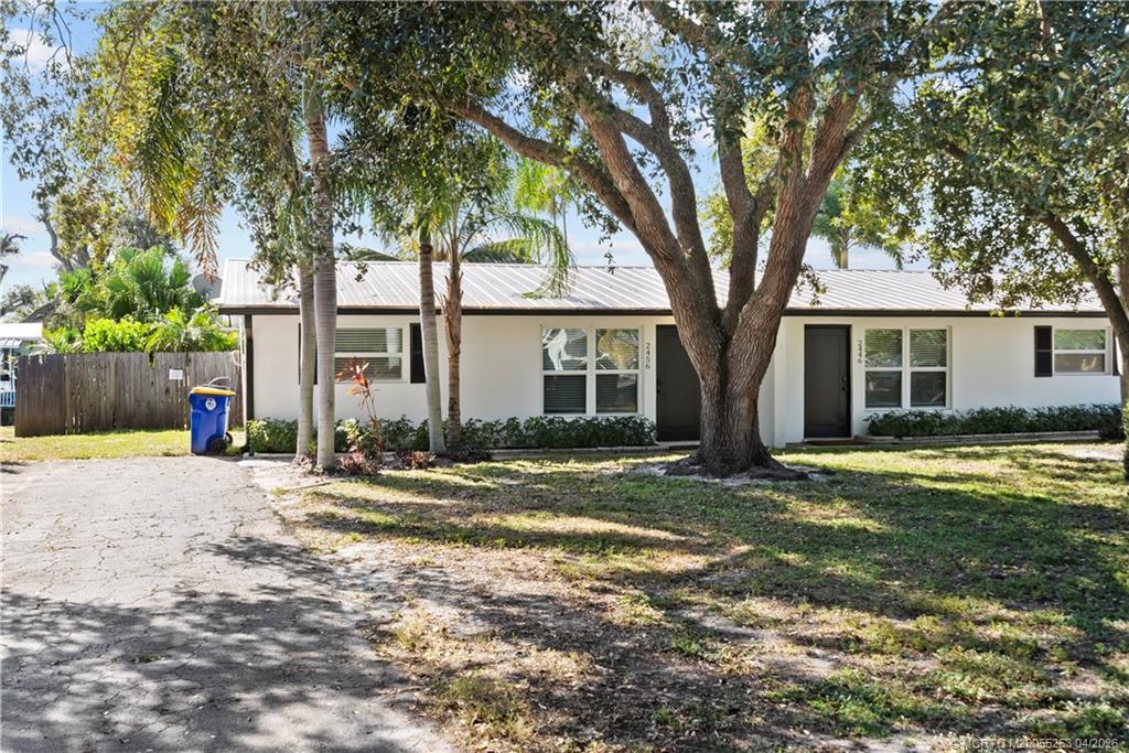 2446-2456 Southwest Hideaway Lane Stuart, FL 34994 - Photo 31 of 42 front view of a house with a yard