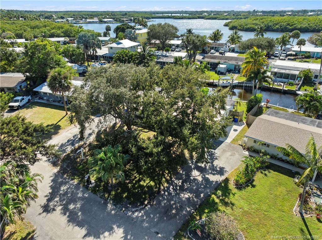 2446-2456 Southwest Hideaway Lane Stuart, FL 34994 - Photo 38 of 42 an aerial view of residential houses with outdoor space and trees