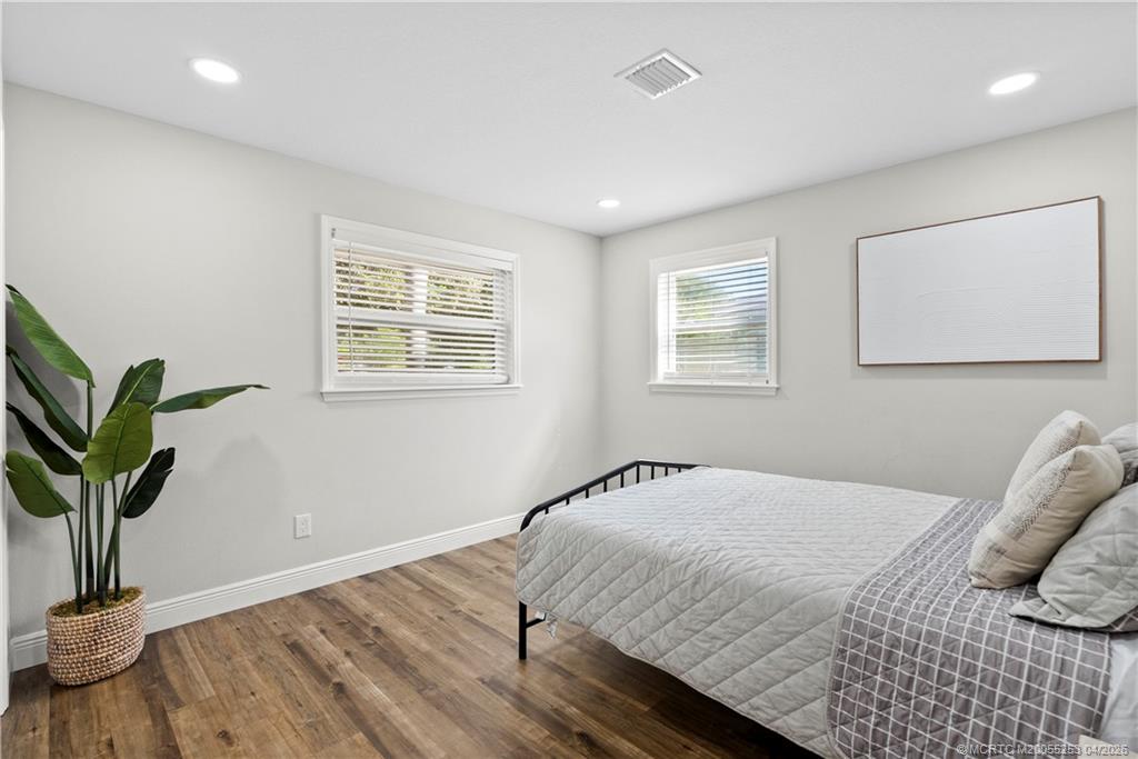 2446-2456 Southwest Hideaway Lane Stuart, FL 34994 - Photo 4 of 42 a bedroom with bed and a window