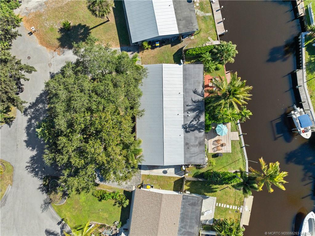 2446-2456 Southwest Hideaway Lane Stuart, FL 34994 - Photo 41 of 42 an aerial view of a house with a yard and garden in the background