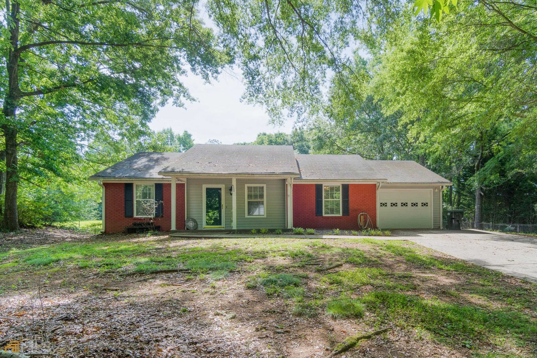 a front view of a house with yard and trees