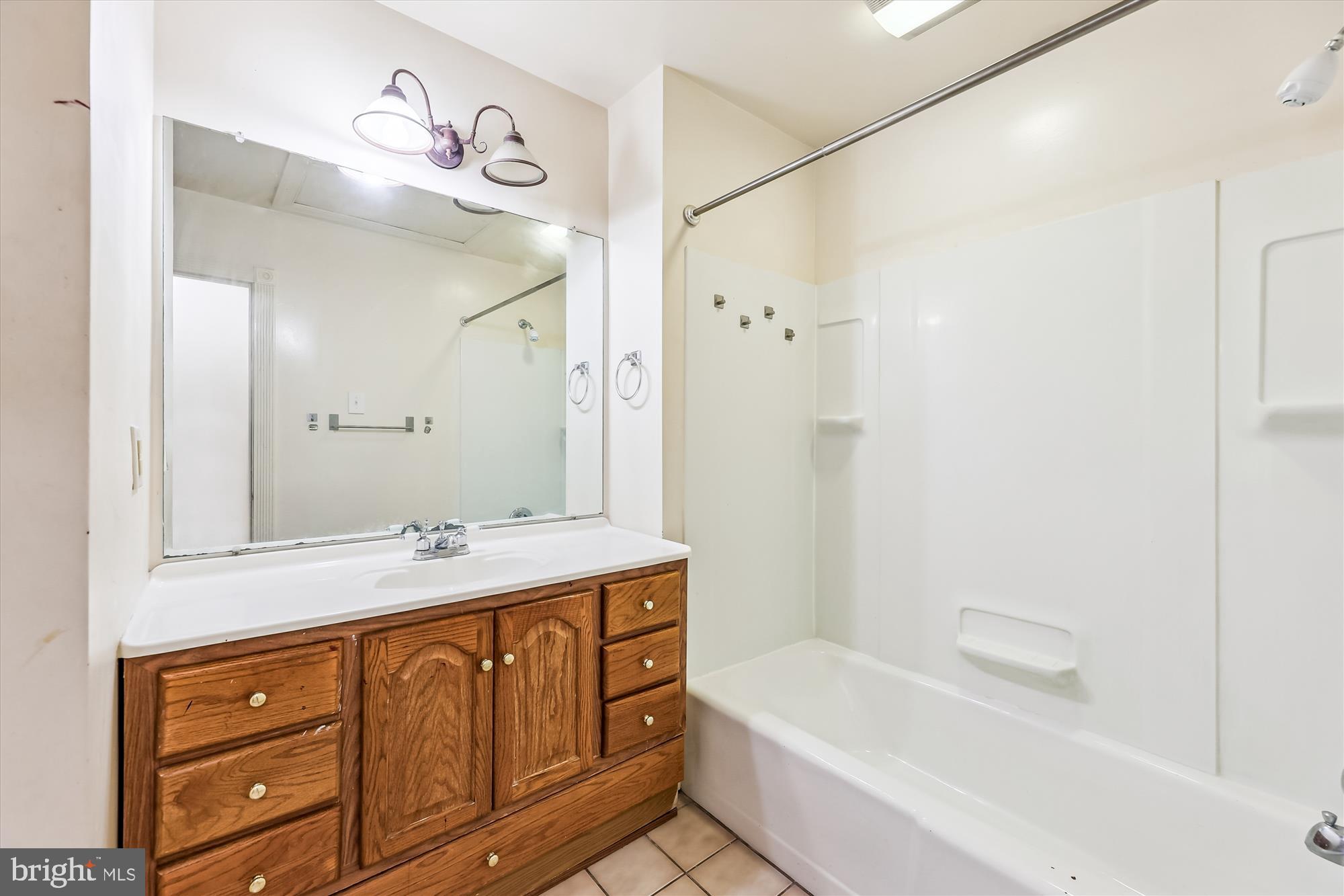 9502 Brandywine Road Clinton, MD 20735 - Photo 12 of 21 a bathroom with a tub sink and mirror