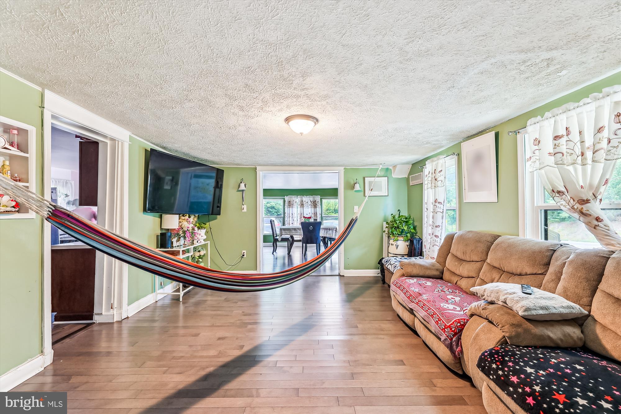 9502 Brandywine Road Clinton, MD 20735 - Photo 7 of 21 a living room with furniture a rug potted plant wooden floor and a large window