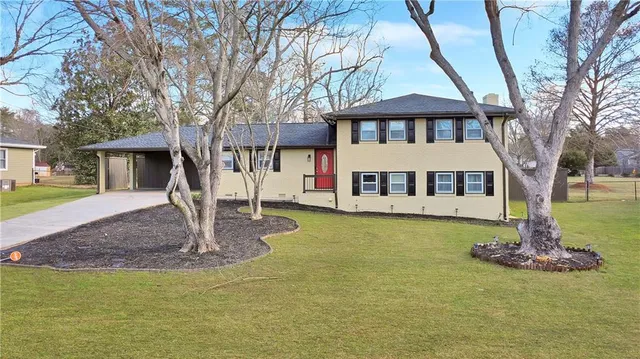 a front view of a house with a garden