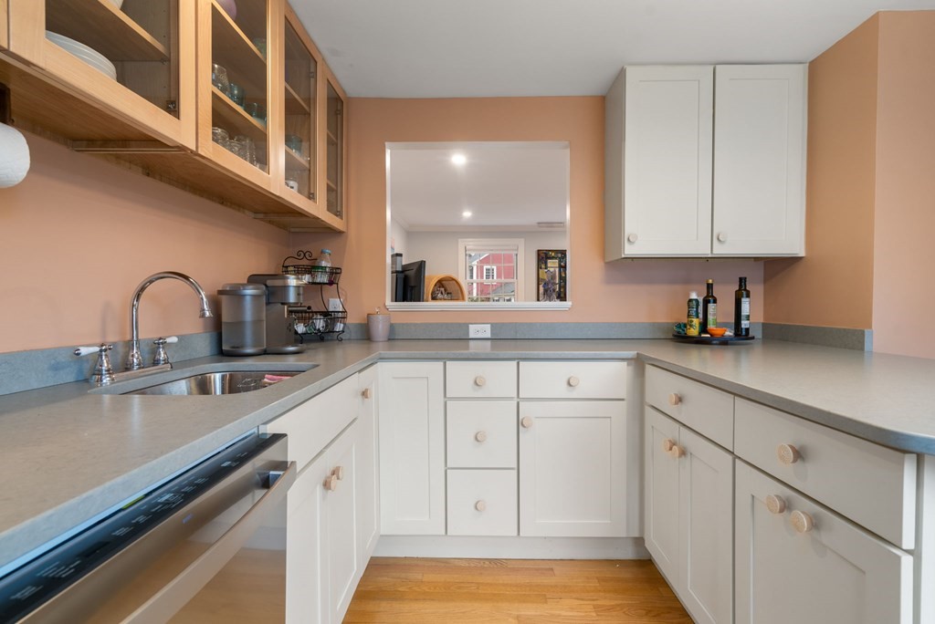 55 Jericho Road, Unit 55 Weston, MA 02493 - Photo 11 of 24 a kitchen with white cabinets and sink