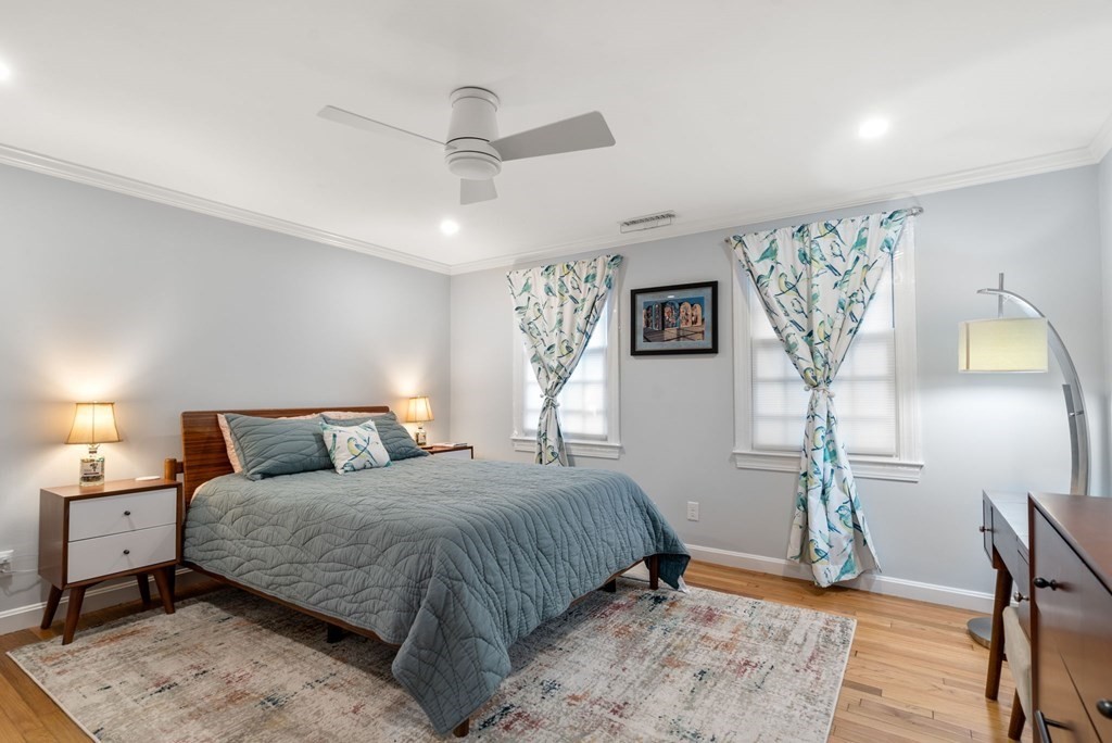 55 Jericho Road, Unit 55 Weston, MA 02493 - Photo 14 of 24 a bedroom with a large bed and a chandelier