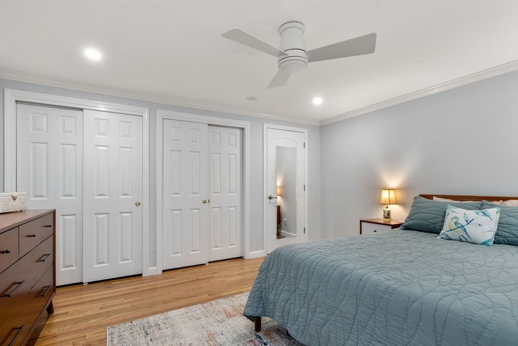 55 Jericho Road, Unit 55 Weston, MA 02493 - Photo 15 of 24 a bedroom with a bed and a chandelier