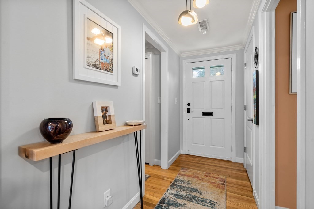 55 Jericho Road, Unit 55 Weston, MA 02493 - Photo 16 of 24 a bedroom with a bed and a chandelier