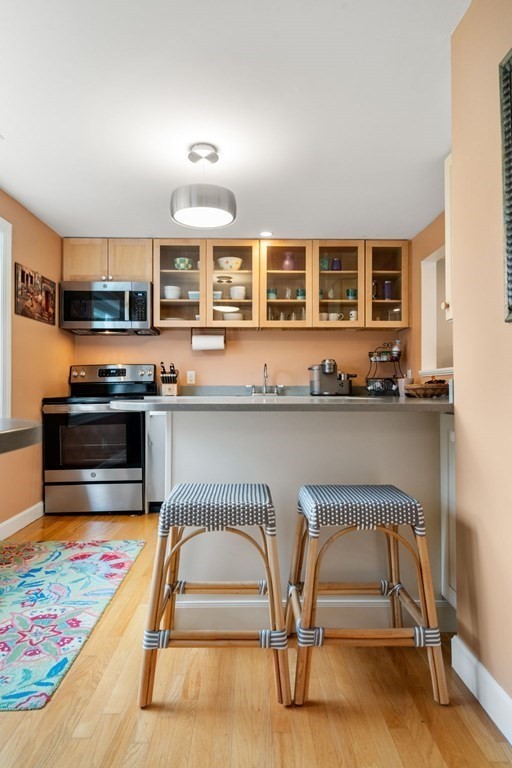 55 Jericho Road, Unit 55 Weston, MA 02493 - Photo 10 of 24 a living room with stainless steel appliances kitchen island granite countertop furniture and a kitchen view