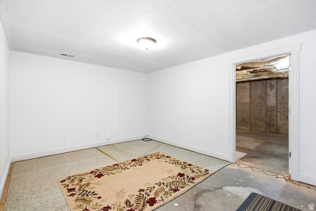1089 West 2325th Street North Layton, UT 84041 - Photo 32 of 40 Finished room with a neutral color palette, baseboard trim, and a ceiling-mounted light fixture