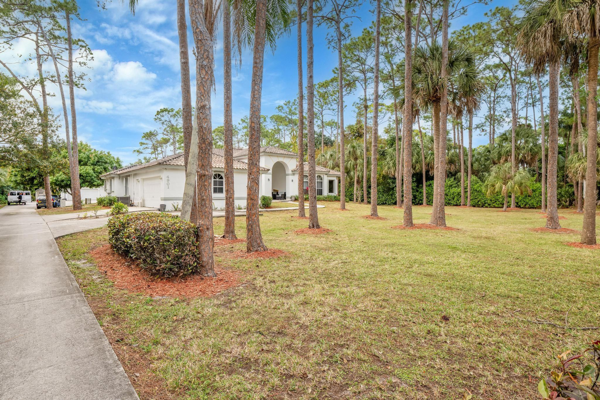 4901 Godfrey Road Parkland, FL 33067 - Photo 22 of 60 a building with trees in front of it