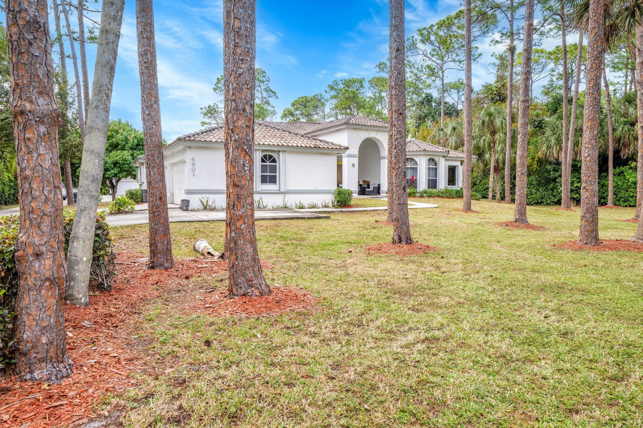 4901 Godfrey Road Parkland, FL 33067 - Photo 24 of 60 a view of a house with a yard and tree s