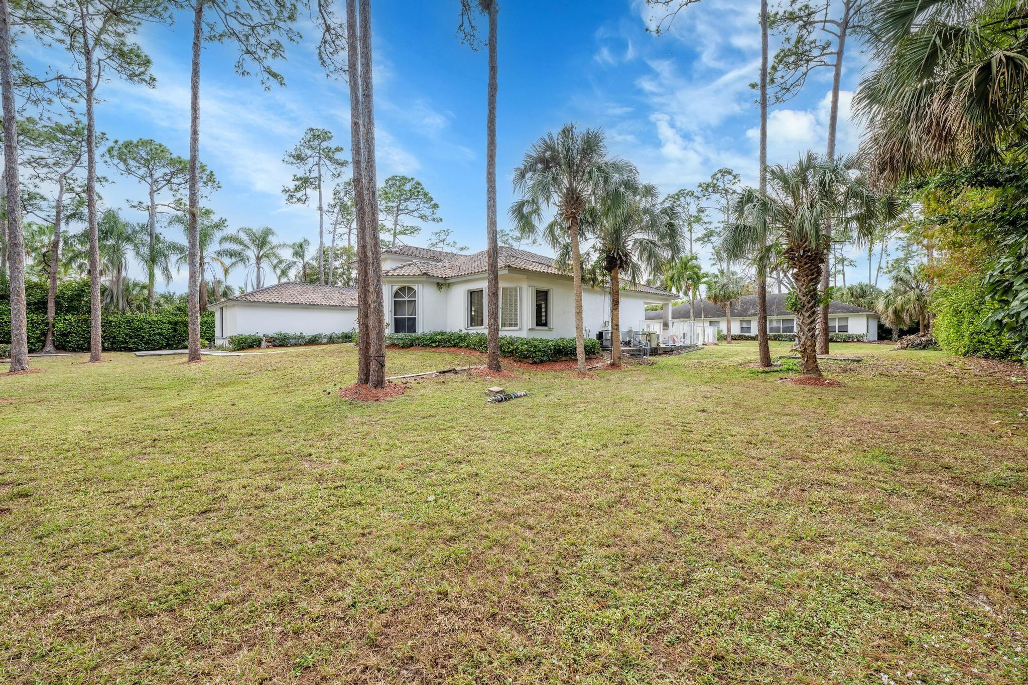 4901 Godfrey Road Parkland, FL 33067 - Photo 32 of 60 a house with garden in front of it