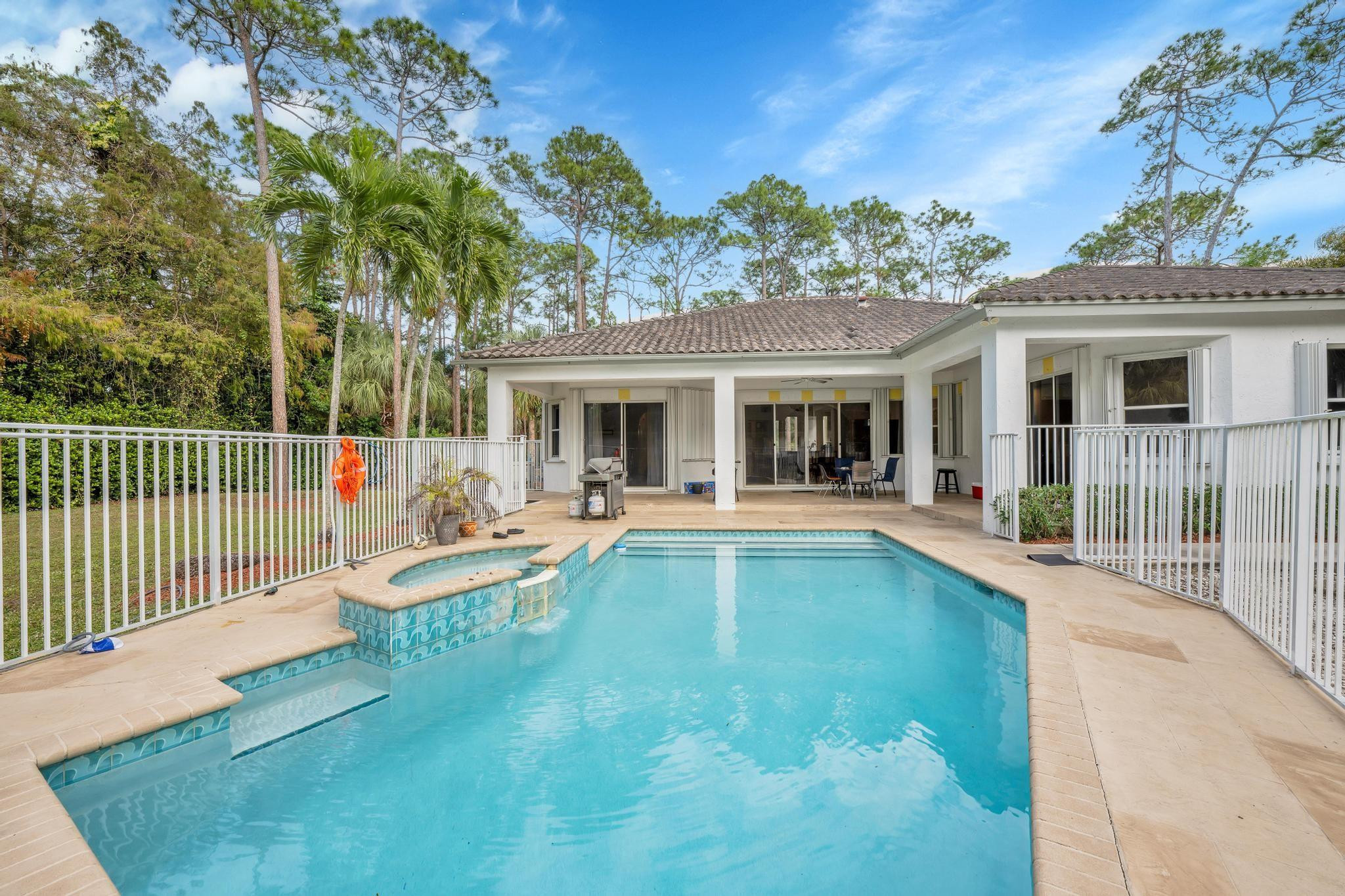 4901 Godfrey Road Parkland, FL 33067 - Photo 33 of 60 a view of a house with a swimming pool and sitting area