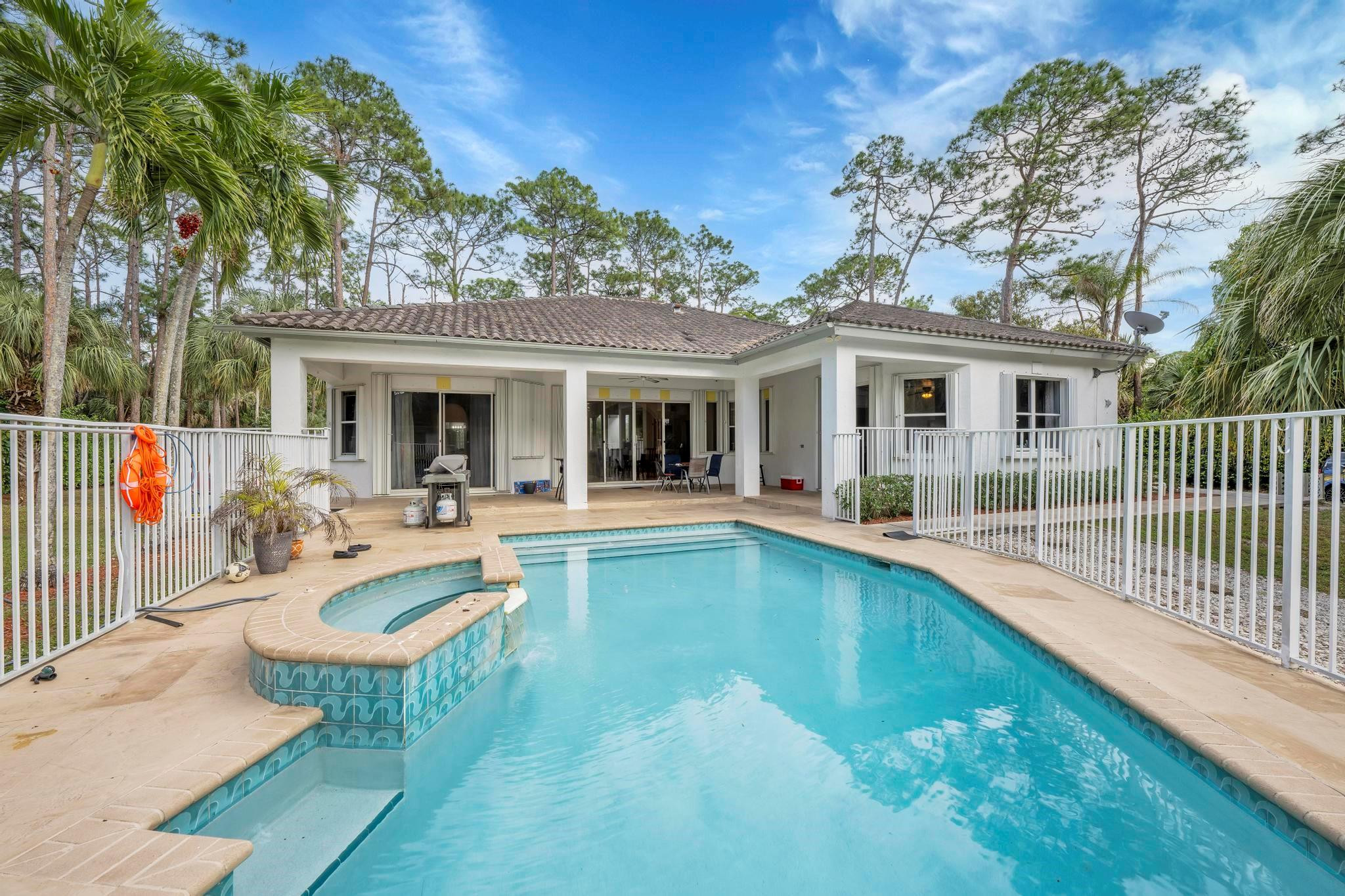 4901 Godfrey Road Parkland, FL 33067 - Photo 34 of 60 a view of a house with swimming pool and porch