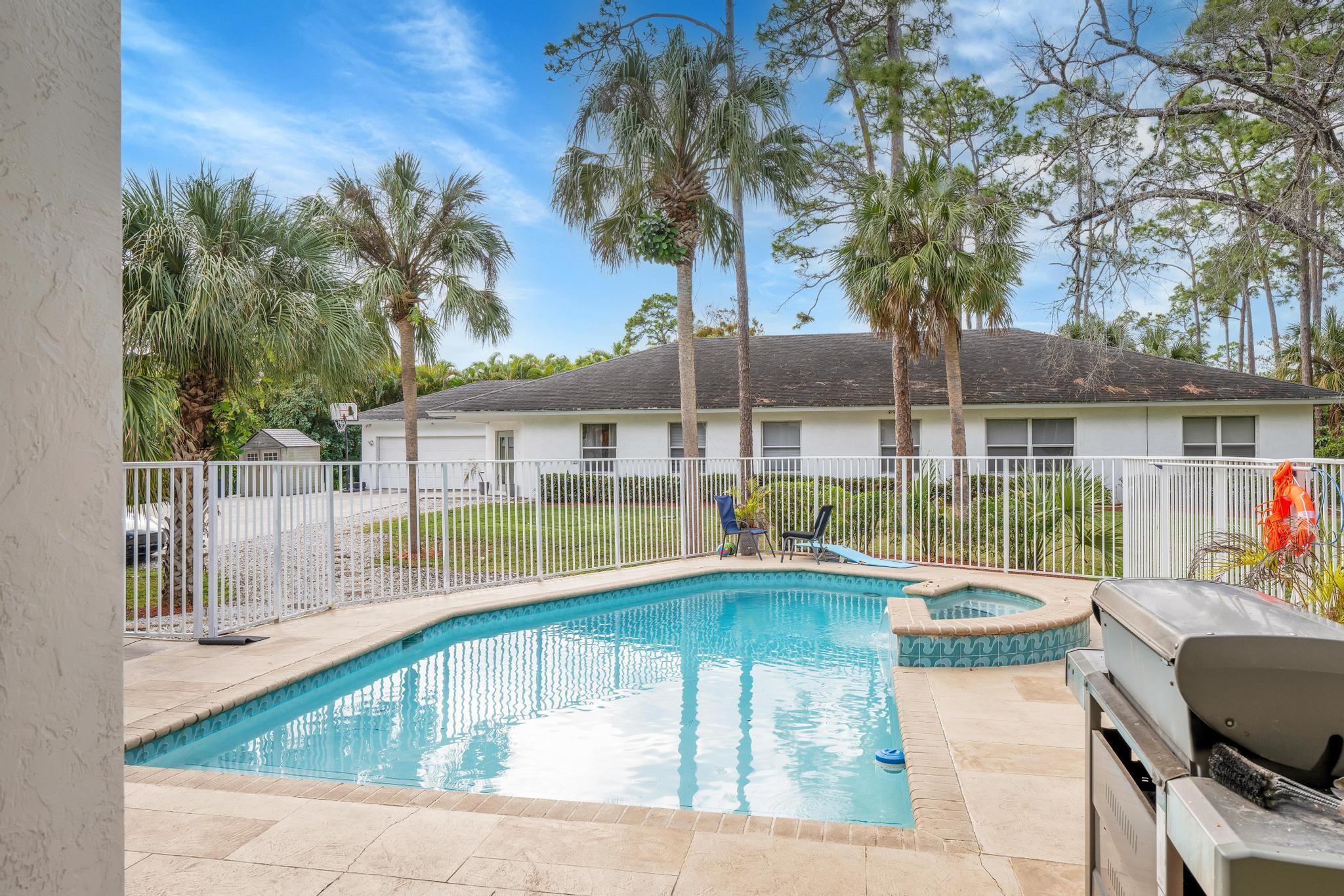4901 Godfrey Road Parkland, FL 33067 - Photo 35 of 60 a swimming pool with outdoor seating and yard