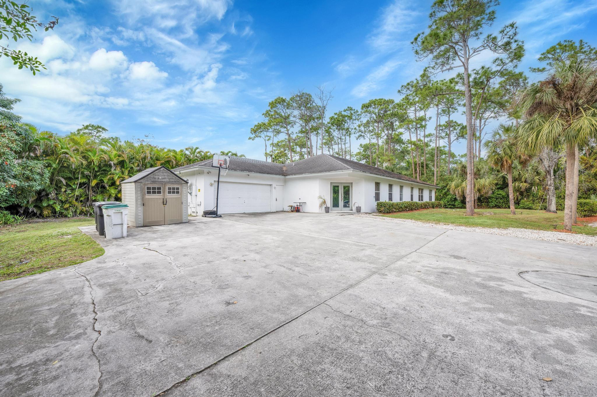 4901 Godfrey Road Parkland, FL 33067 - Photo 37 of 60 a front view of a house with a yard and garage