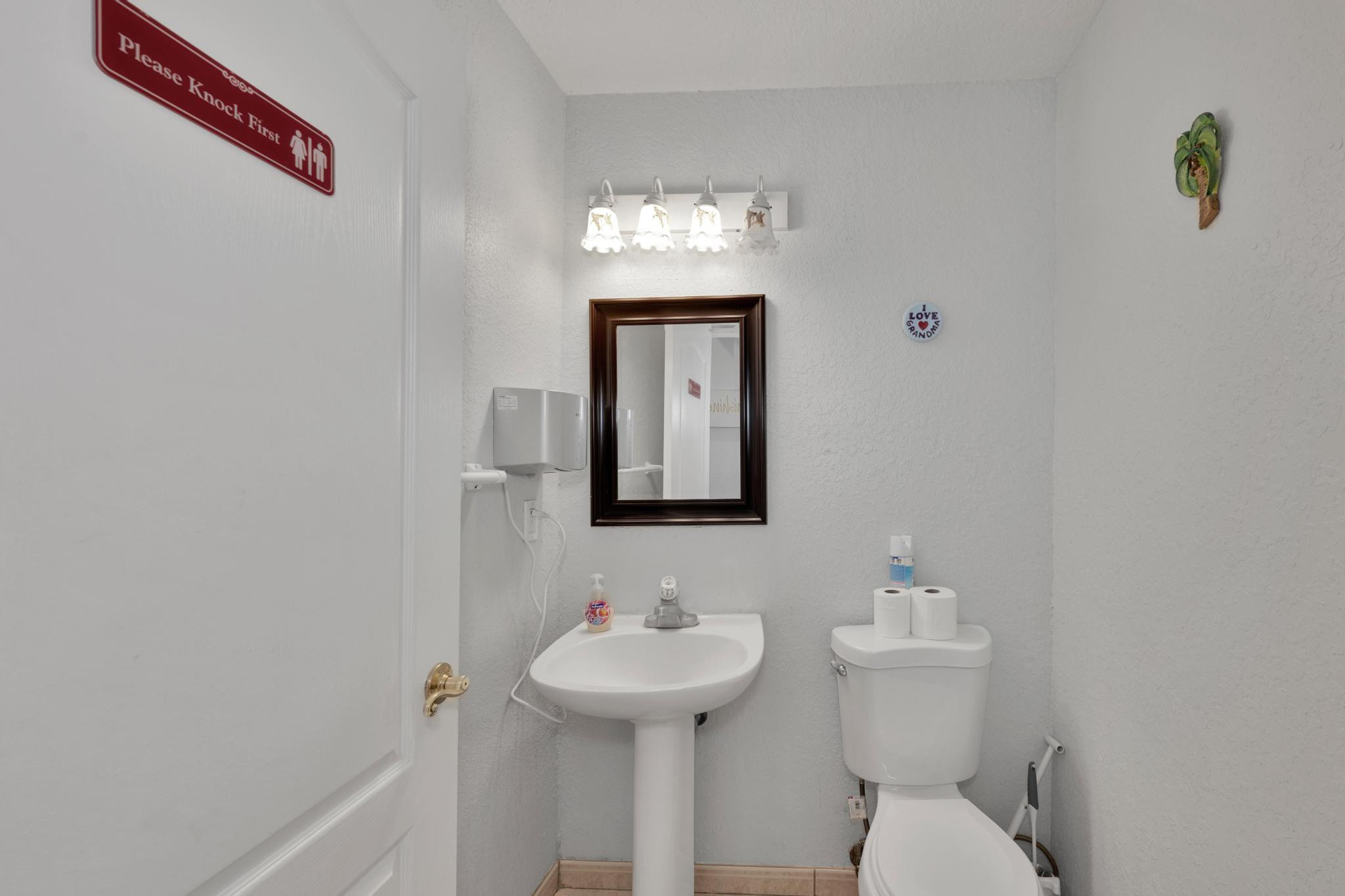 4901 Godfrey Road Parkland, FL 33067 - Photo 43 of 60 a bathroom with a toilet sink and mirror